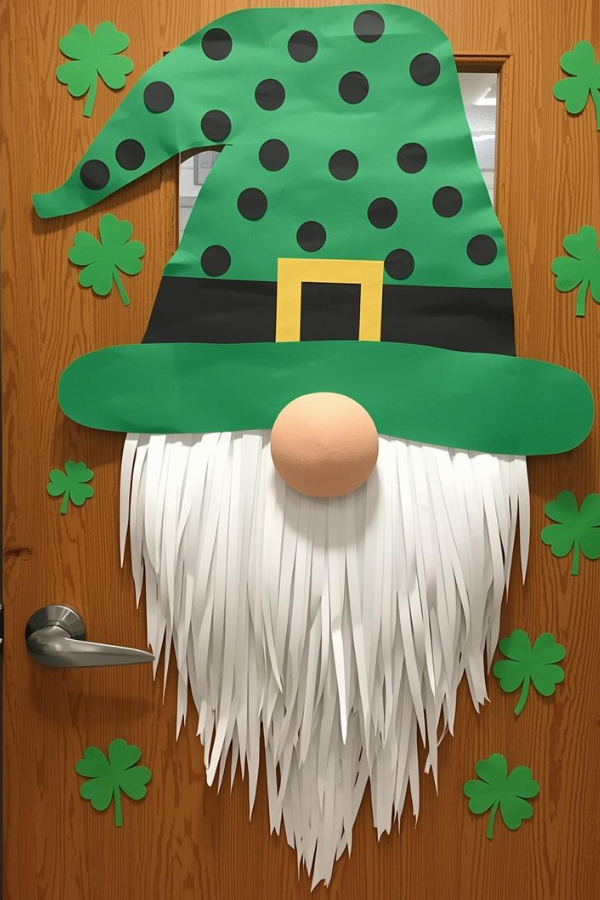 St. Patrick’s Day classroom door decorated with a paper leprechaun gnome wearing a green hat, white beard, and surrounded by green shamrocks