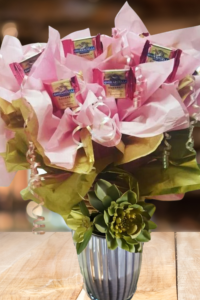 Cute gift basket Idea - fill a pail with nail supplies and a bouquet of flowers.