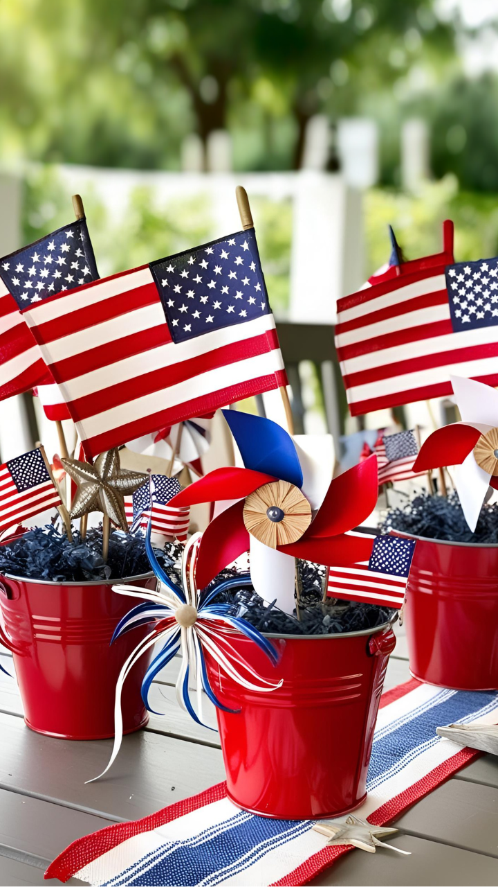 DIY patriotic centerpieces made with red buckets filled with American flags, pinwheels, and patriotic decorations, perfect for Fourth of July or Memorial Day table décor.