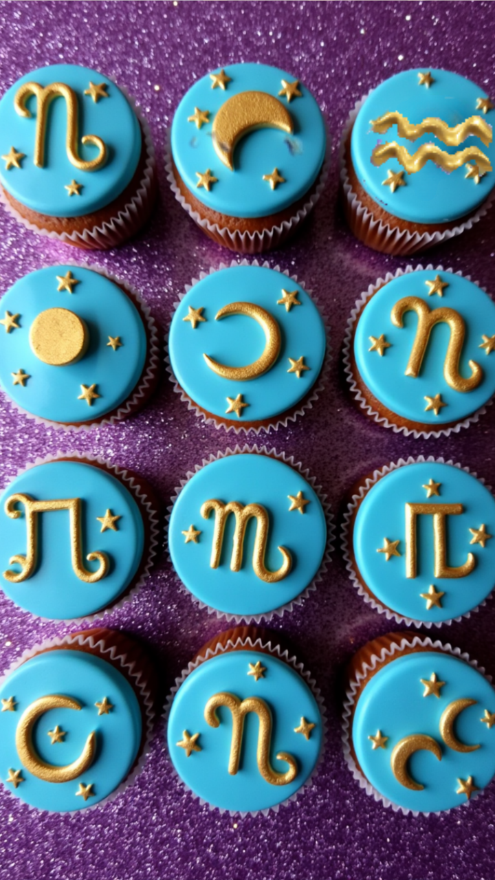 Zodiac cupcakes with gold symbols and stars on blue fondant, perfect for an astrology party or Aquarius birthday.