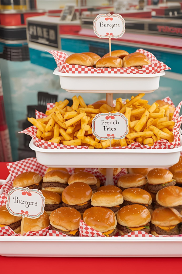 Retro soda shop burger and fries display with mini sliders on a tiered stand and red checkered liners