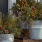 Rustic winter porch decor with pinecone arrangements in galvanized buckets and warm string lights