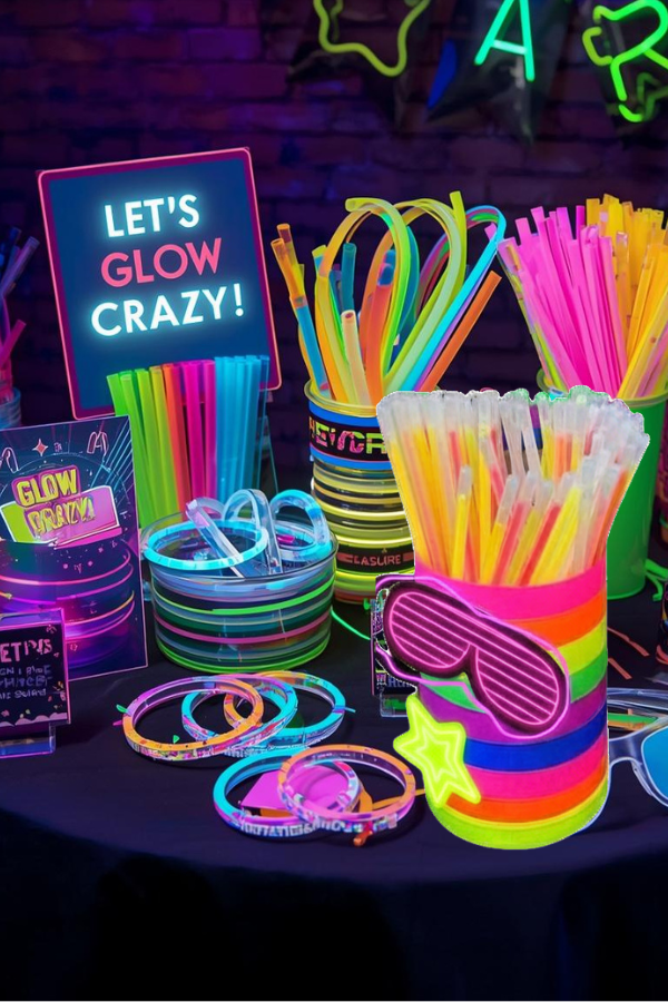 Colorful glow party table with neon cups, glow sticks, and bright accessories