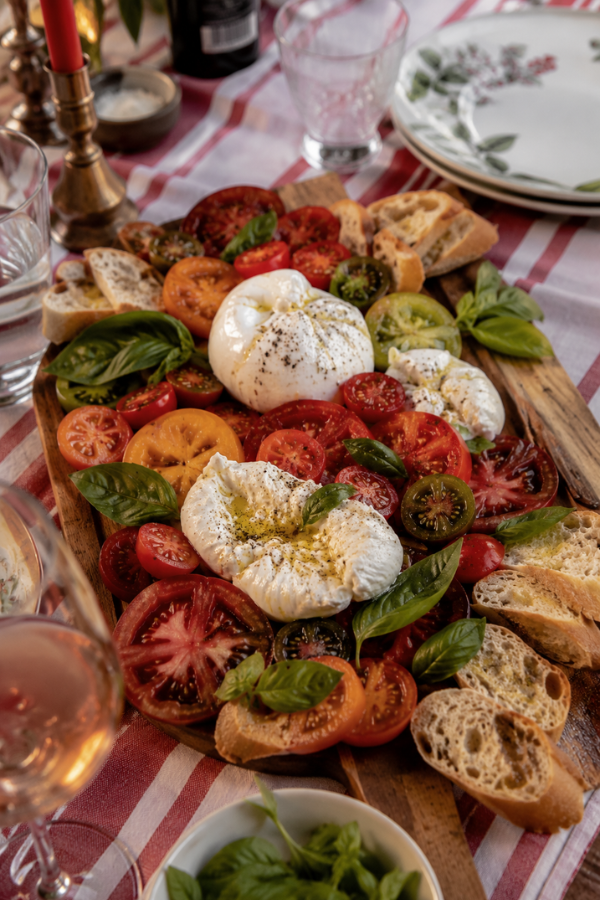 Burrata and Caprese board with heirloom tomatoes and fresh basil.